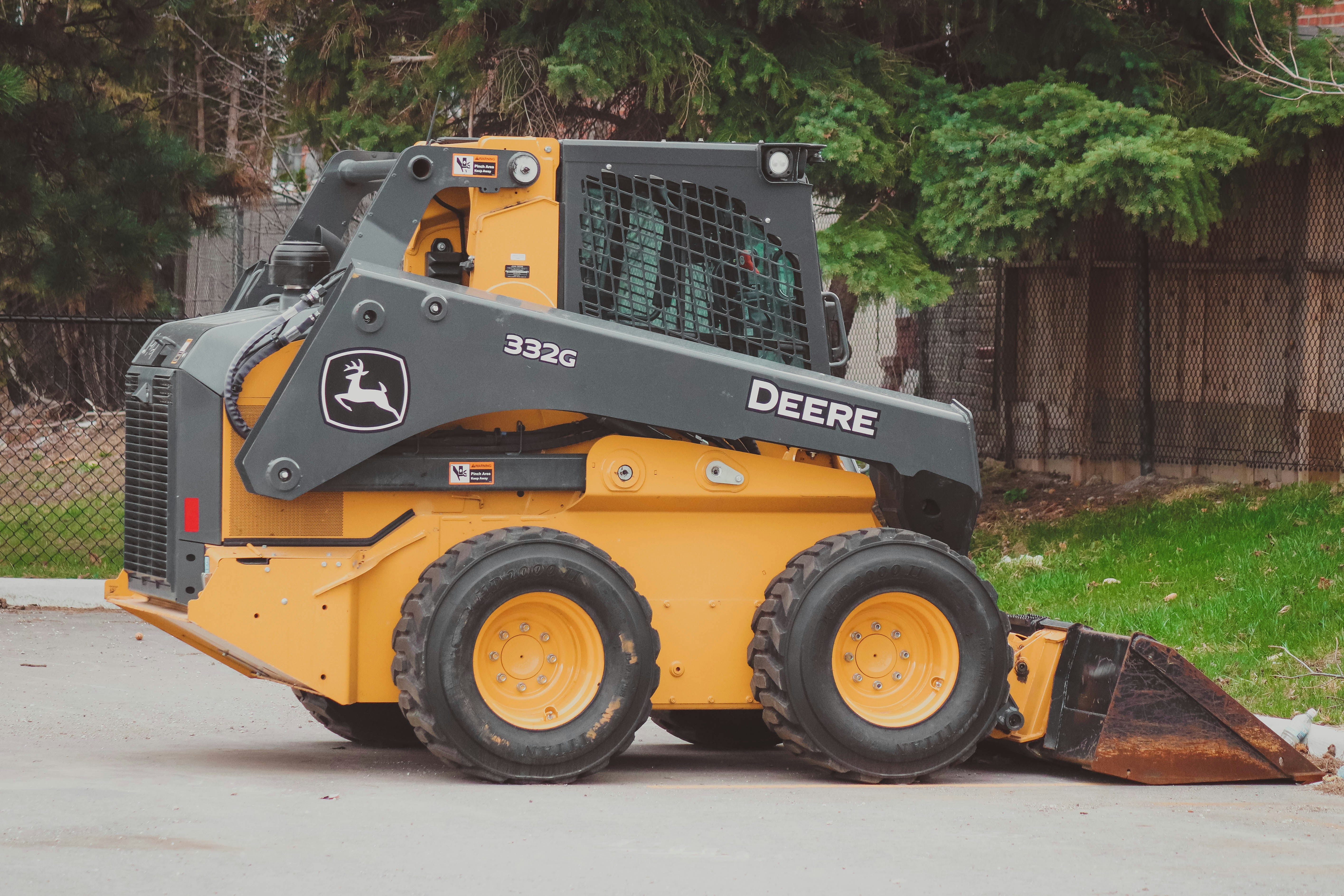 John Deere 332G Skid Steer with bucket attachment.