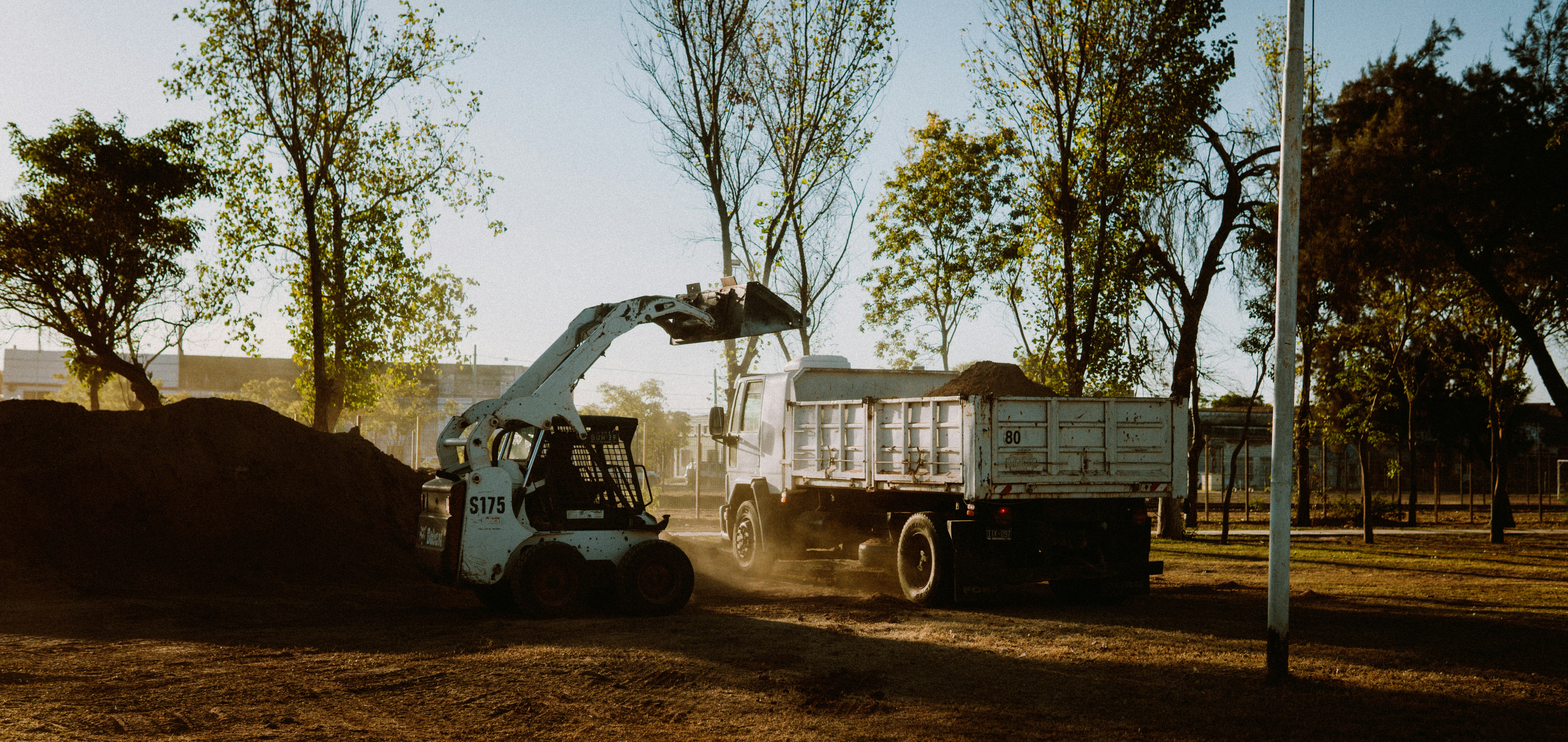 Bobcat Skid Steer Loading Dirt into Truck