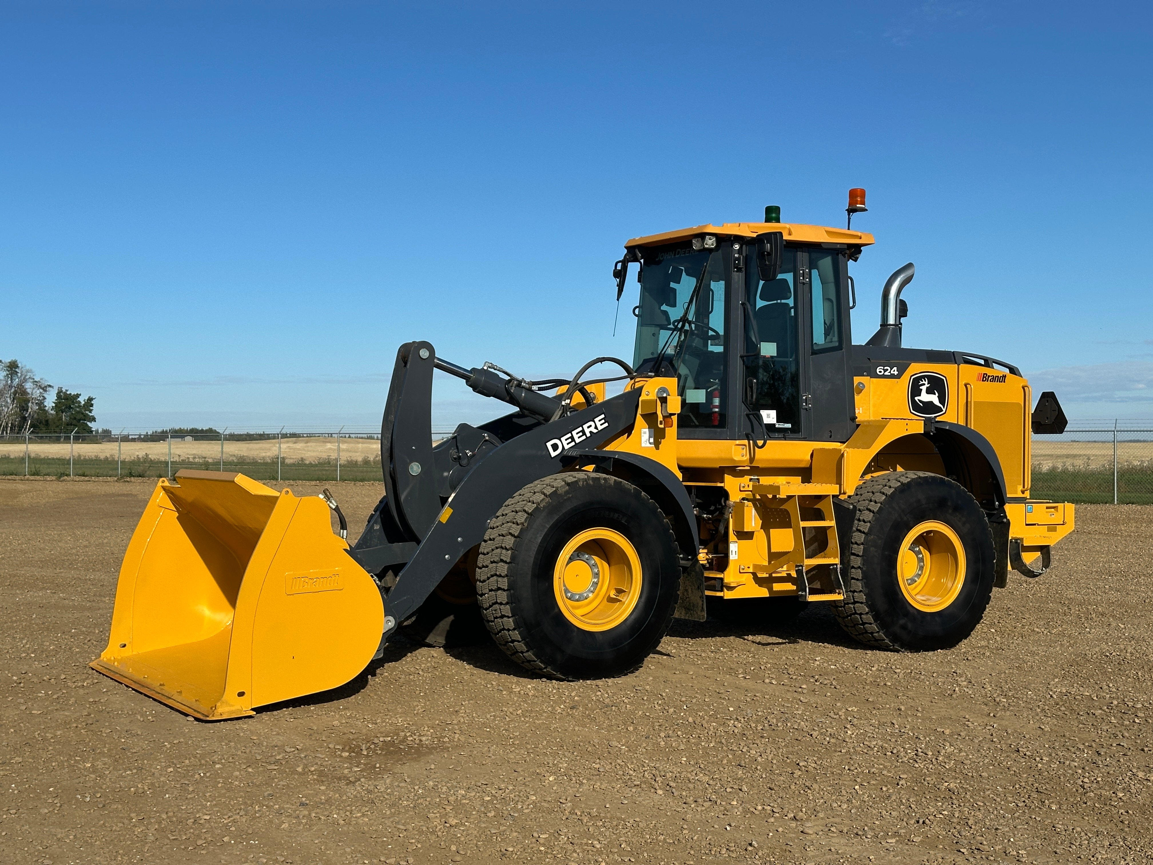 Seller photographing the cab and controls of a used wheel loader